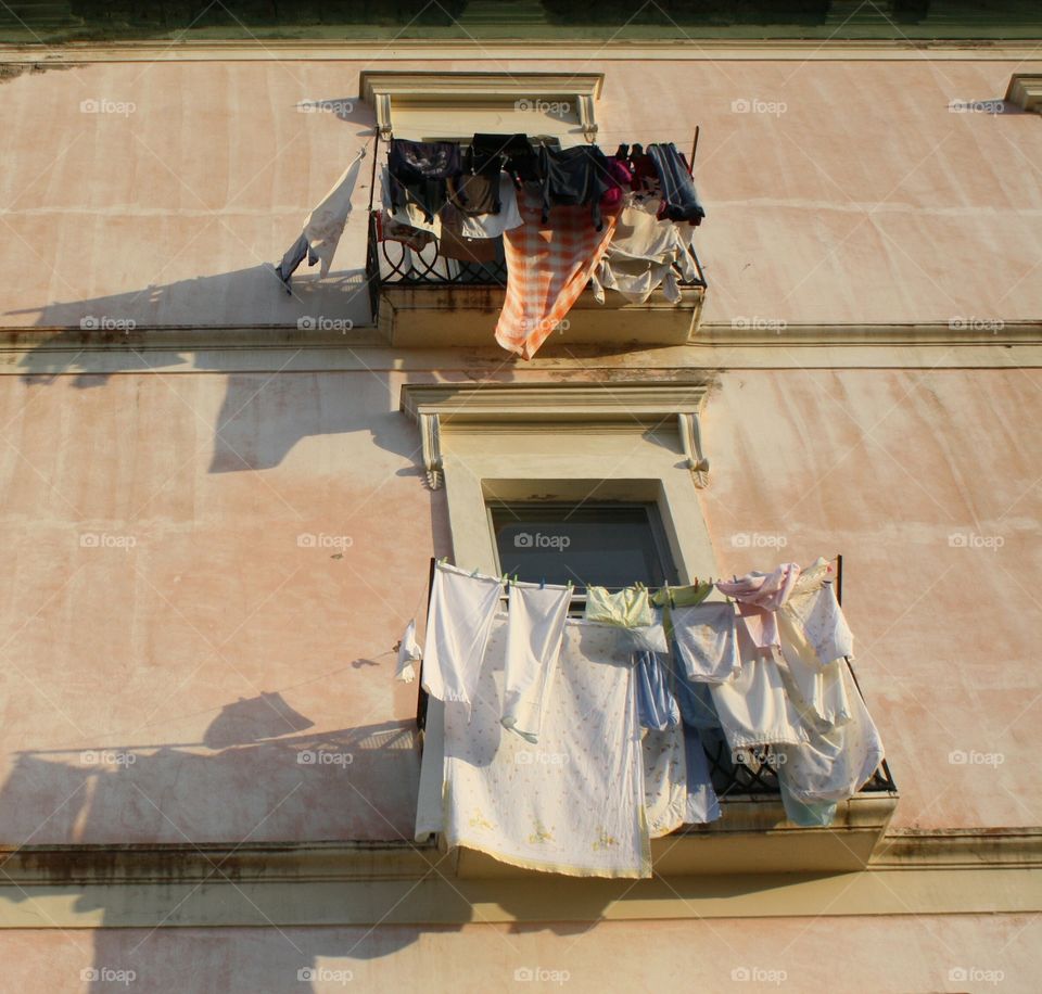 Building view from below, drying laundry on one side