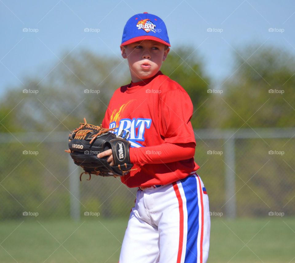 Portrait of boy in baseball cap with glove