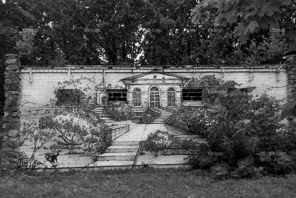 art graffiti house drawing on a wall and  trees in the park summer time black and white background