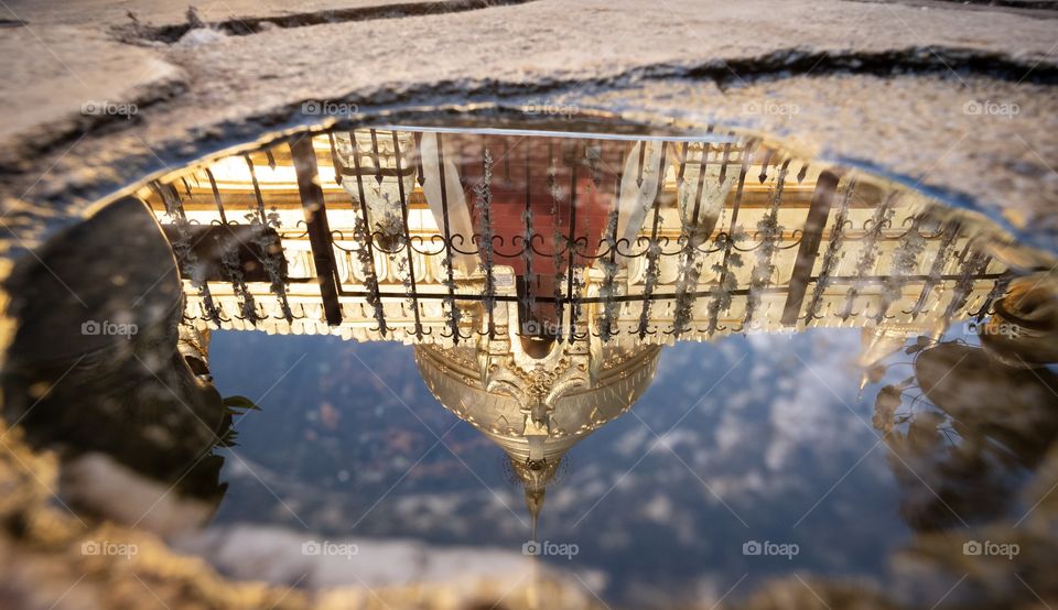 Super reflection of beautiful Myanmar pagoda in a small Puddle which shape look like human eye