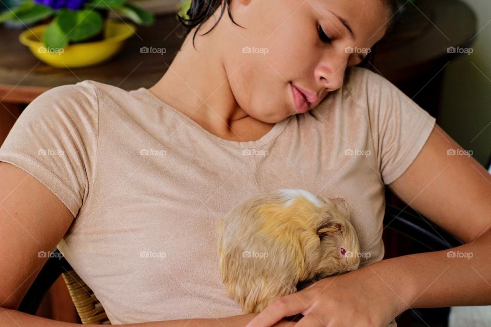 Girl enjoying her guinea pig