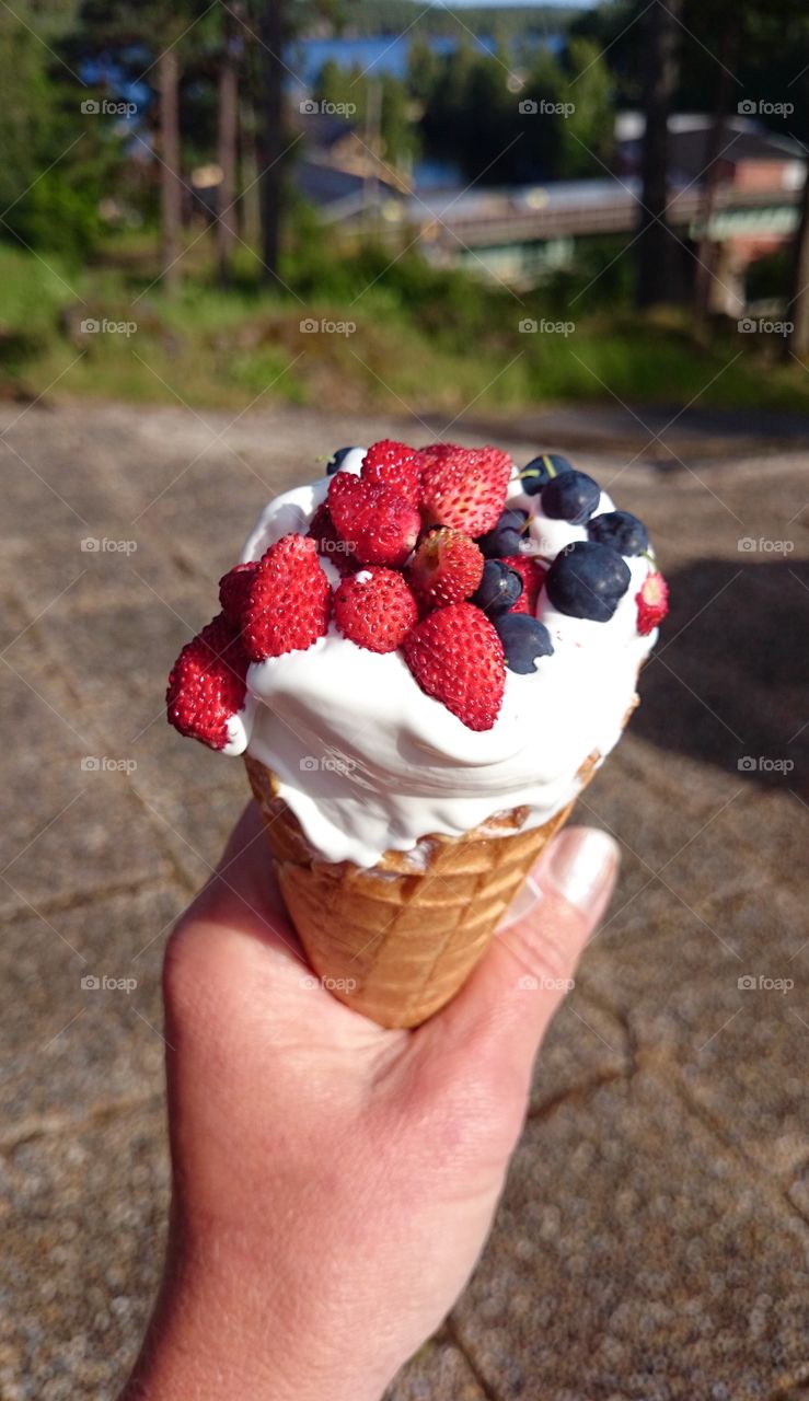 Ice cream cone with fresh berries