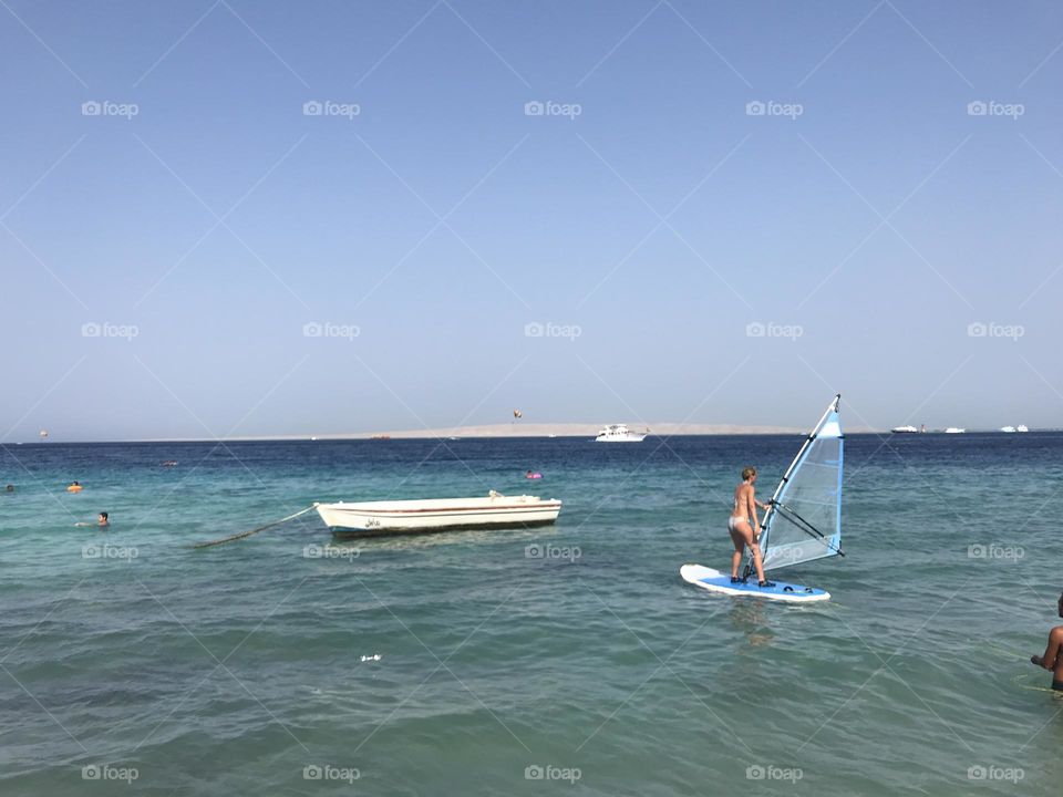 A girl on a surfing board on the sea