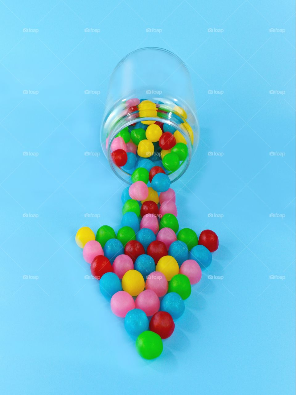 candies in a arrow shape on blue