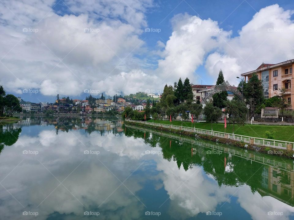 Sapa lake with reflection of Blue sky and clouds.