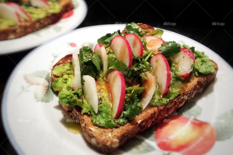 Avocado toast with radishes and cilantro on whole grain wheat bread my favorite sandwich