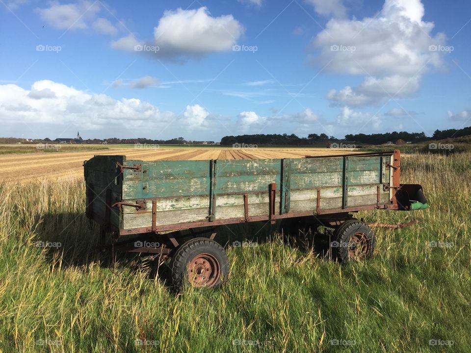 An old tractor wagon standing on a piece of farmland on the Dutch isle of Texel
