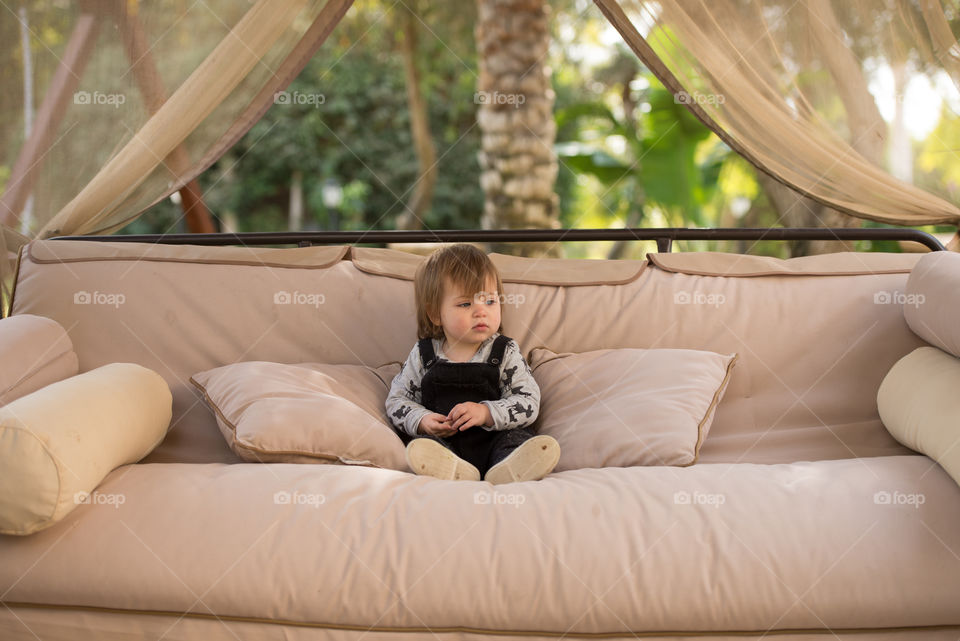 baby on a swing sofa outdoors