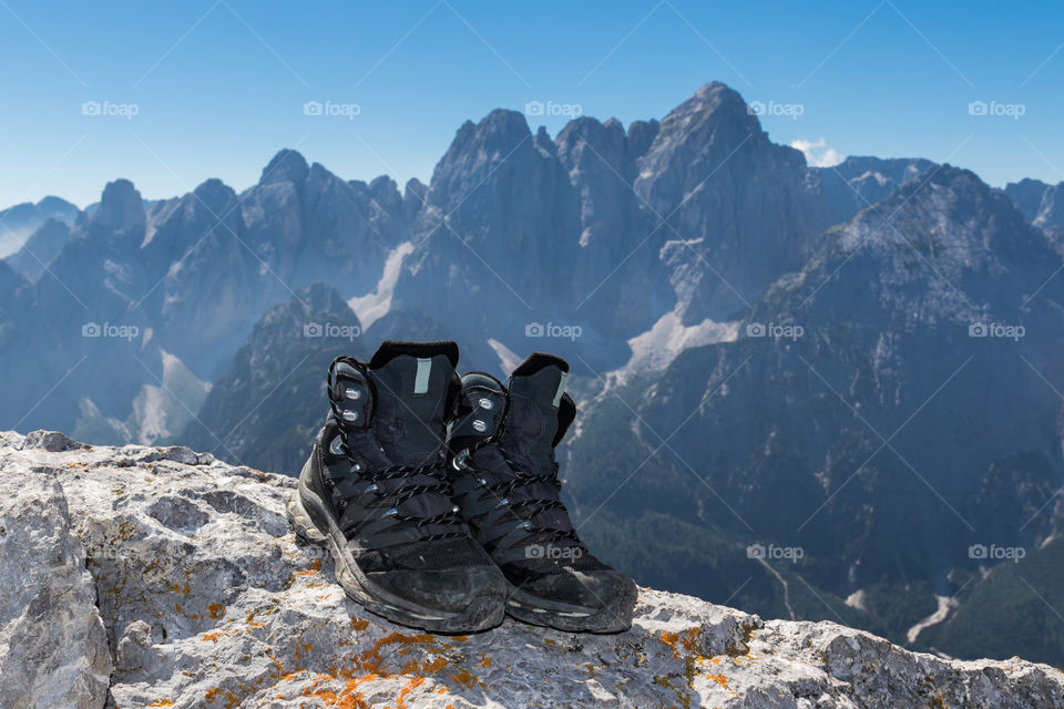 Hiking boots at the top of Cima del Cacciatore (2.071 m), Julian Alps, Italy