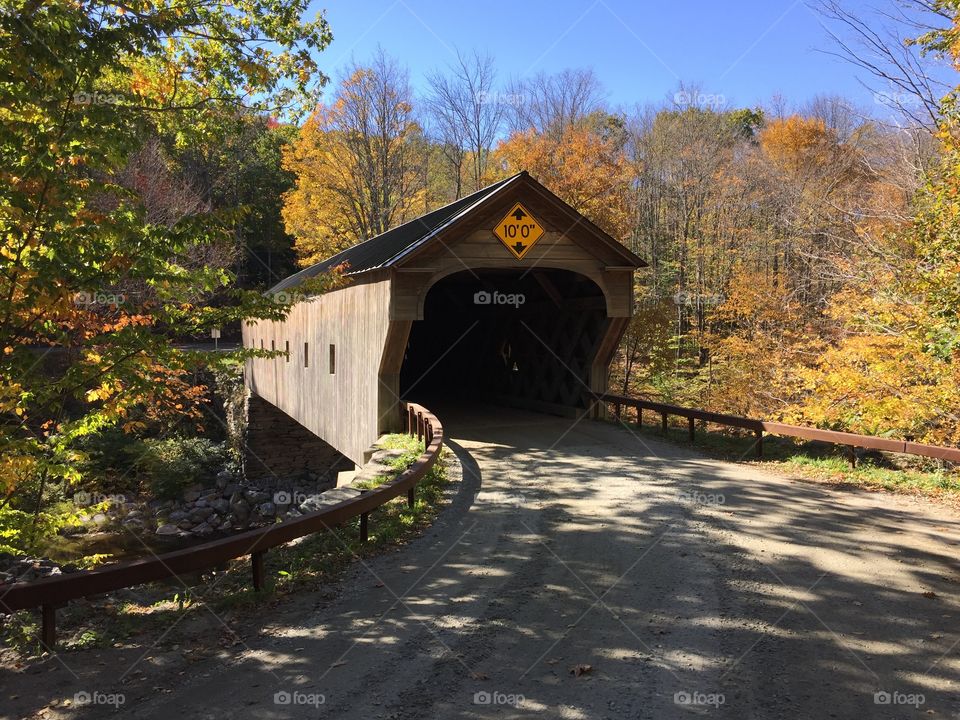 Covered bridge in Vermont shows off brilliant fall foliage. 