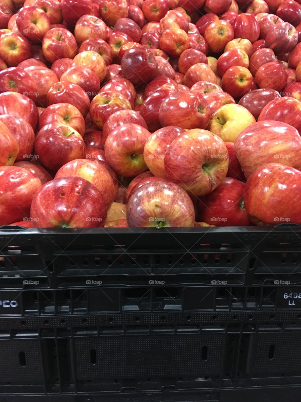 Bunch of red apples on display in crates 