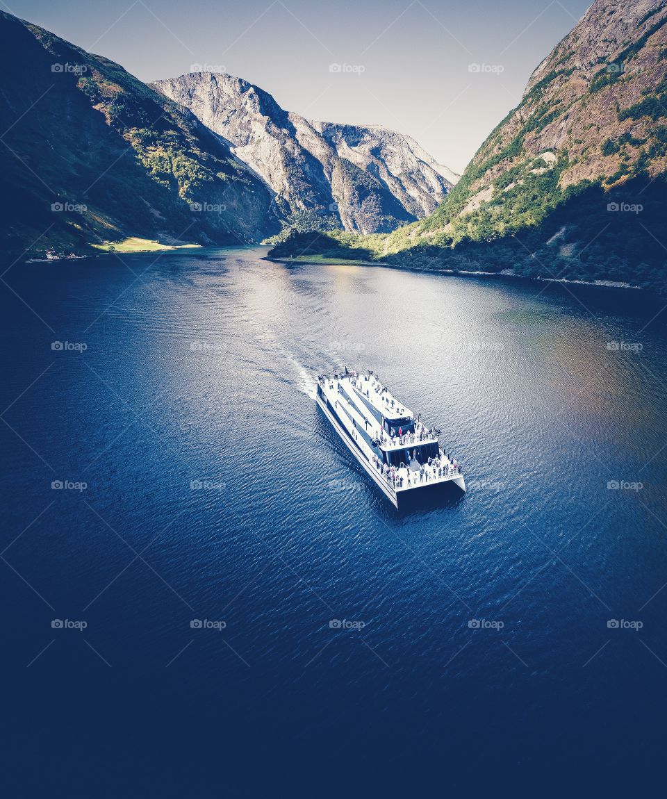 Boat through fjord aerial photography 