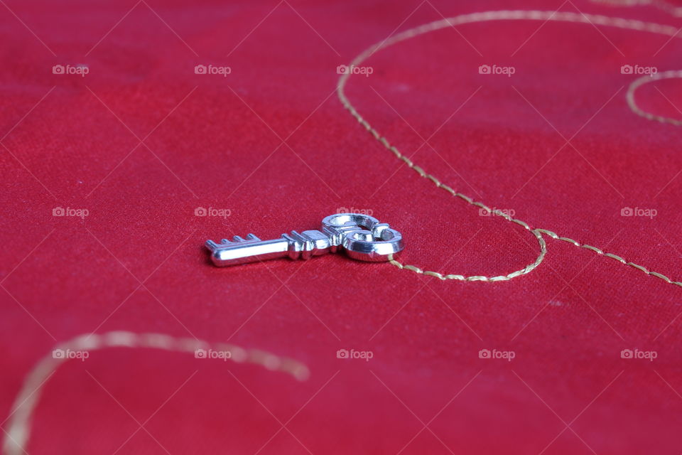 iron miniature key on red background