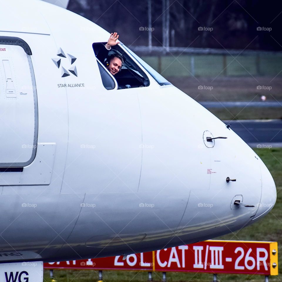 Pilot waving from the cockpit 