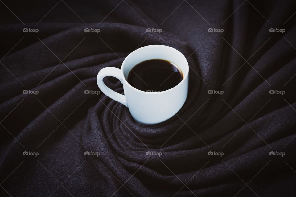white mug in black cloth