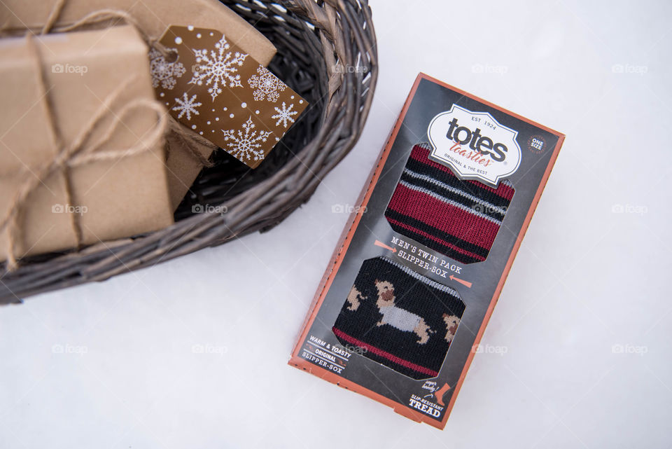 Flat lay of a packaged gift set of socks for the holidays in the snow