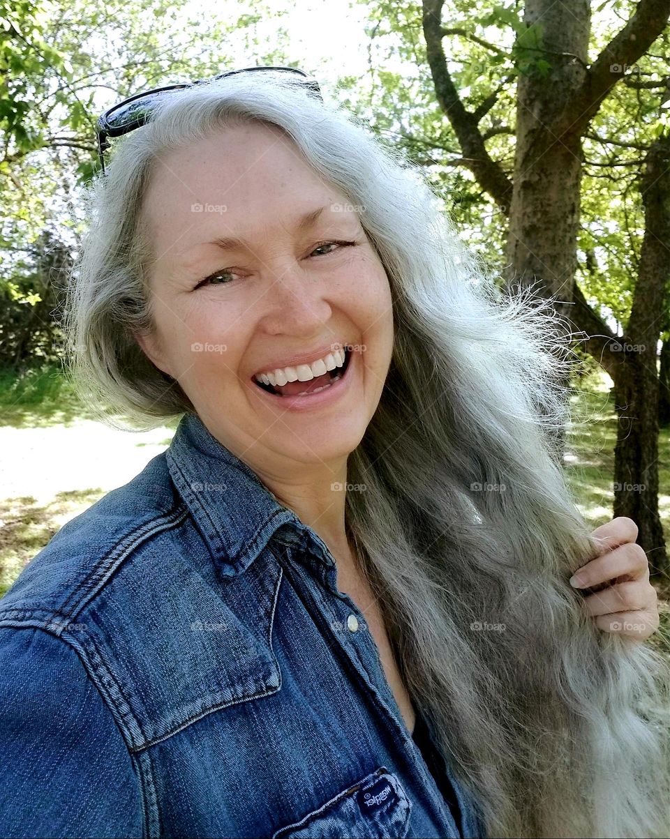 Smiling woman outside with Salt & Pepper Gray hair