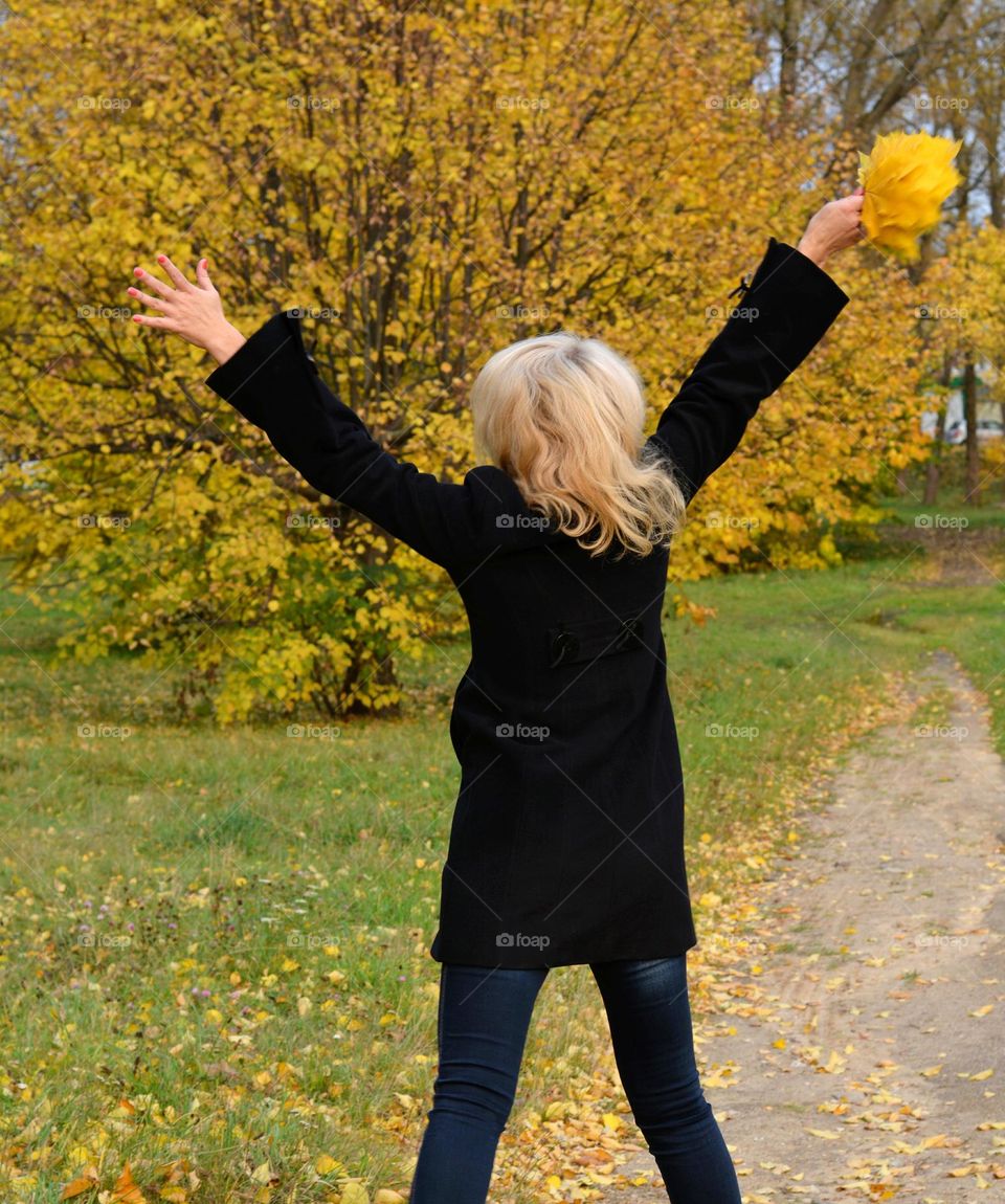 woman with autumn leaves flying autumn nature lovers