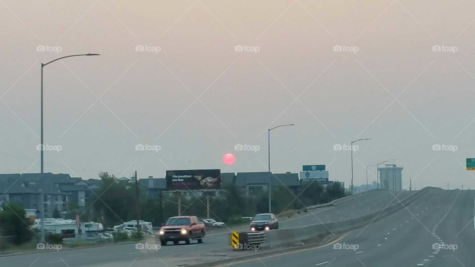 Color of the sun due to smoke from Forrest fires in surrounding states!