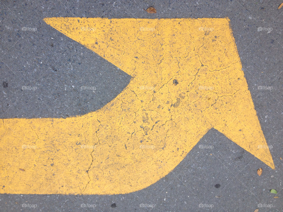 Yellow transit signal painted on asphalt