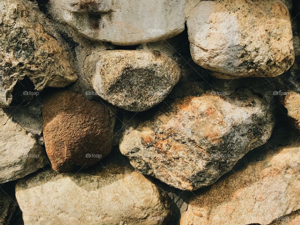 Close up of a rock wall made up of a bunch of beautiful, abstract rocks 
