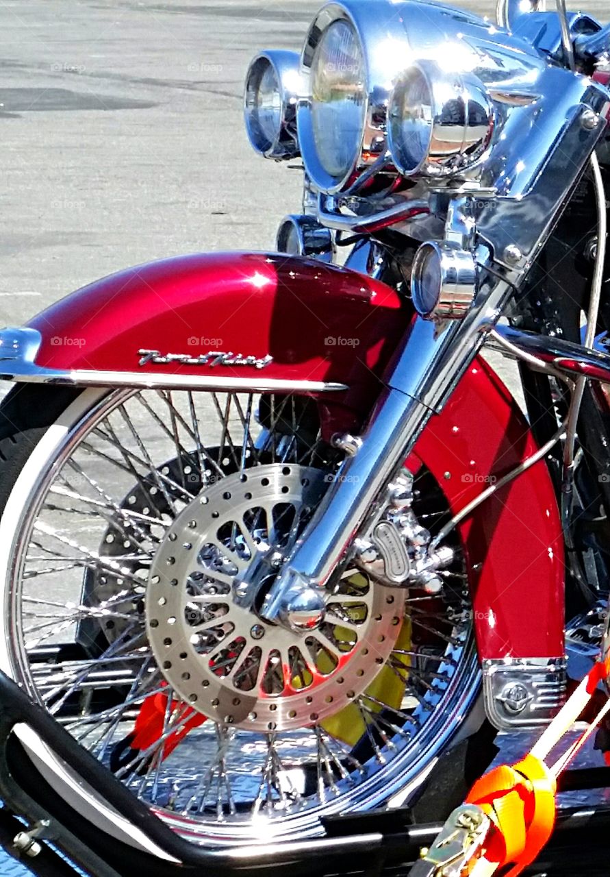 Motorcycle Wheel. Gleaming motorcycle seen in parking lot.