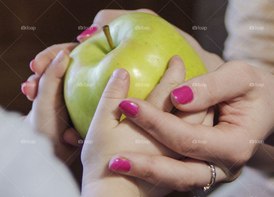 Mother with a small child holding an apple