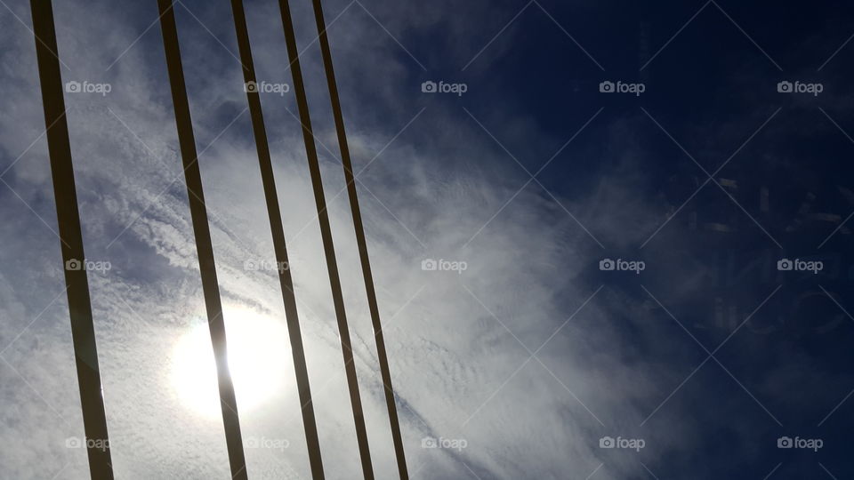 The sun burns brightly above the Sunshine Skyway Bridge.