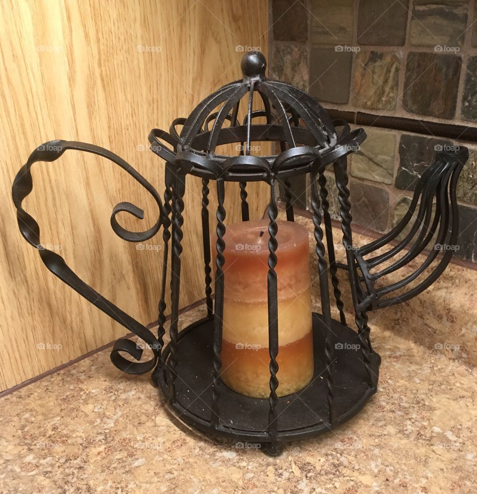 A teapot shaped candle holder.