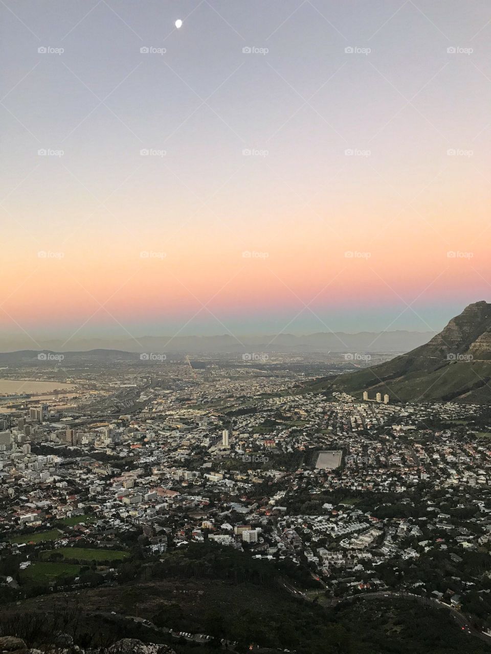 This photo captured on Lion’s Head Mountain in Cape Town, South Africa during my hiking.The sky is becoming pink and blue before the beautiful orange sunset. Nature is beautiful!