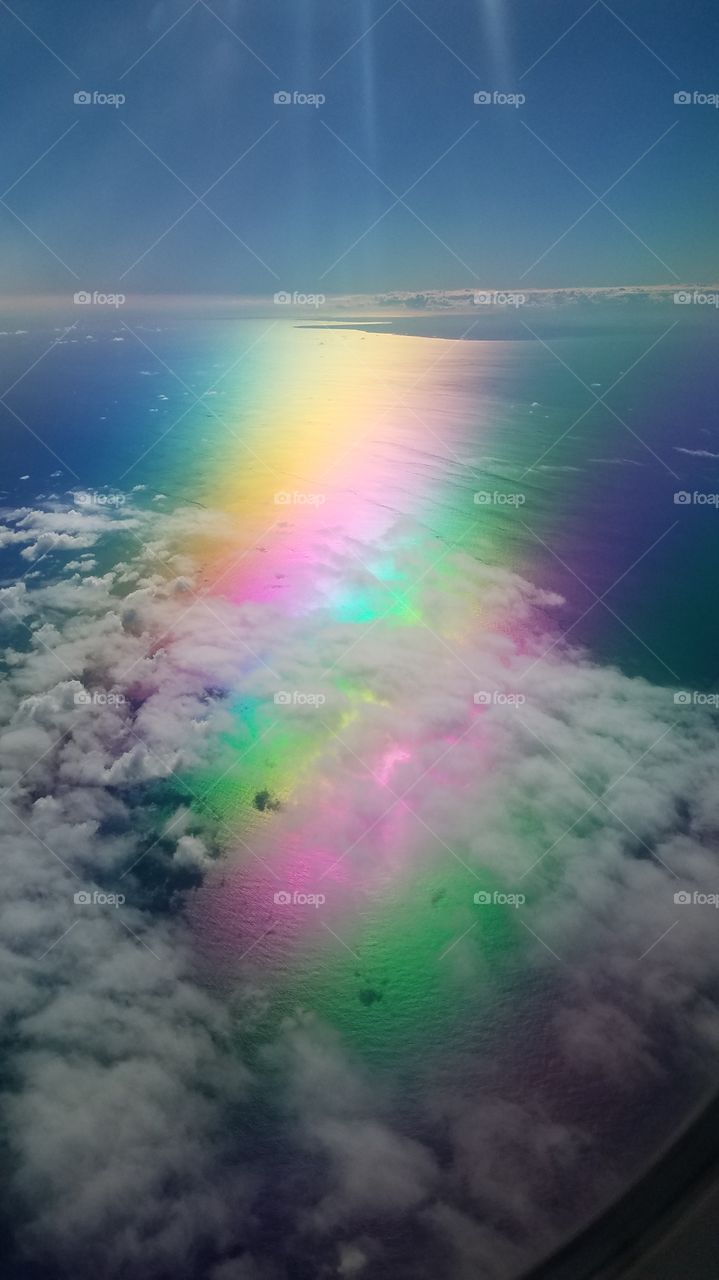 Rainbow of polarized reflection aerial shot with Dominican Republic in the background