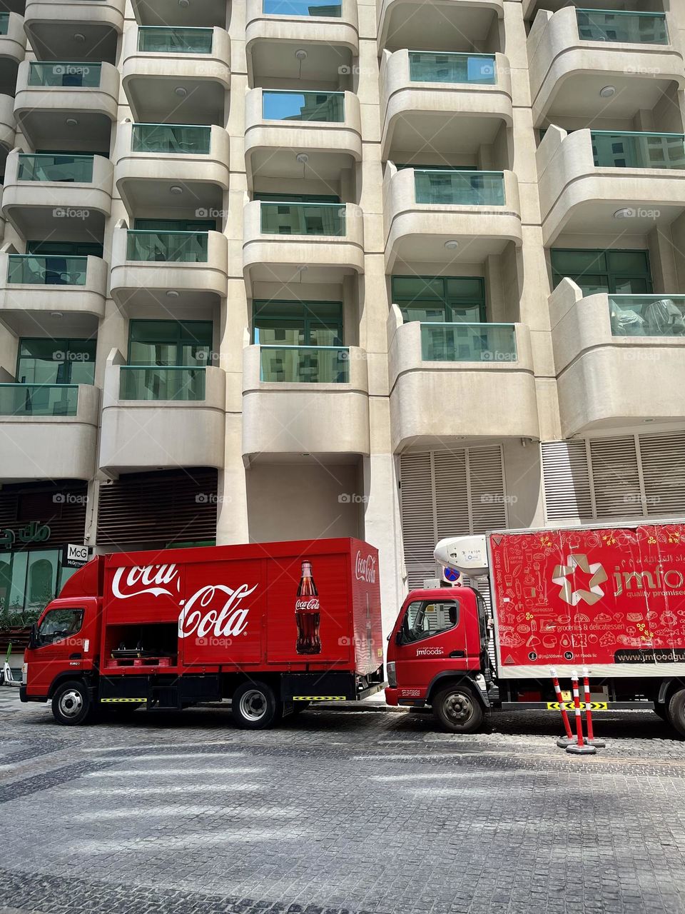 Coca Cola truck in front of a modern Dubai building