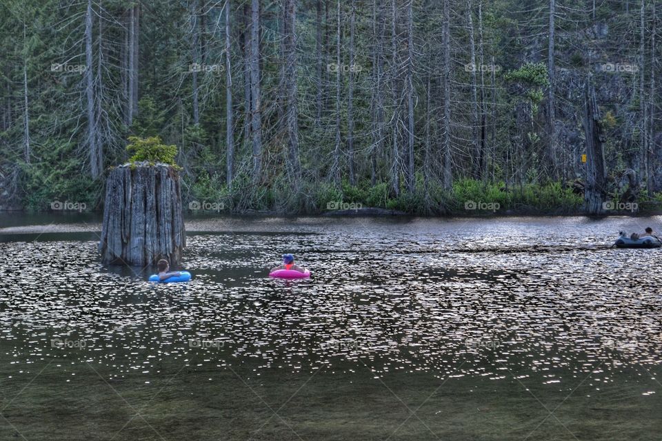 Float tubing on mountain lake reservoir . Float tubing on mountain lake reservoir 