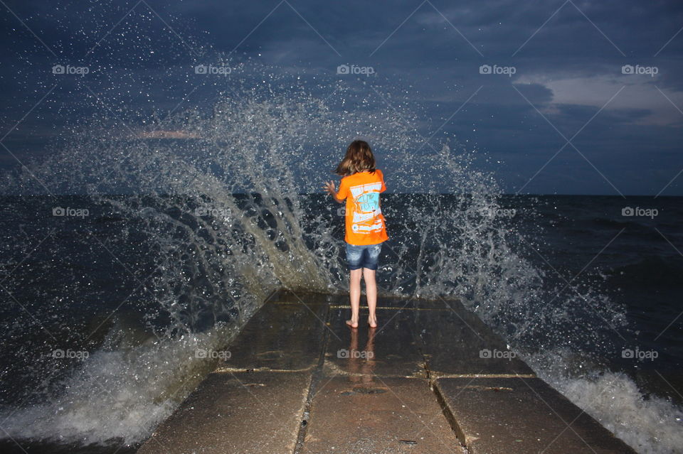 Lake Erie breakers making a splash. Lake Erie breakers making a splash as girl tests how close is close enough