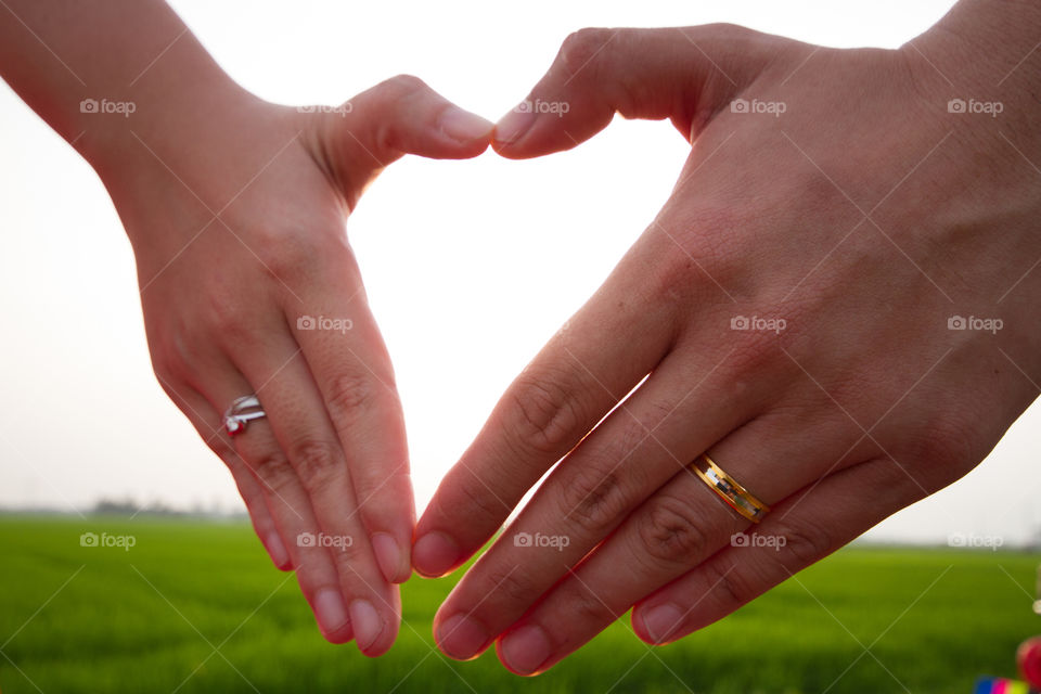 Couple making heart shape with hands