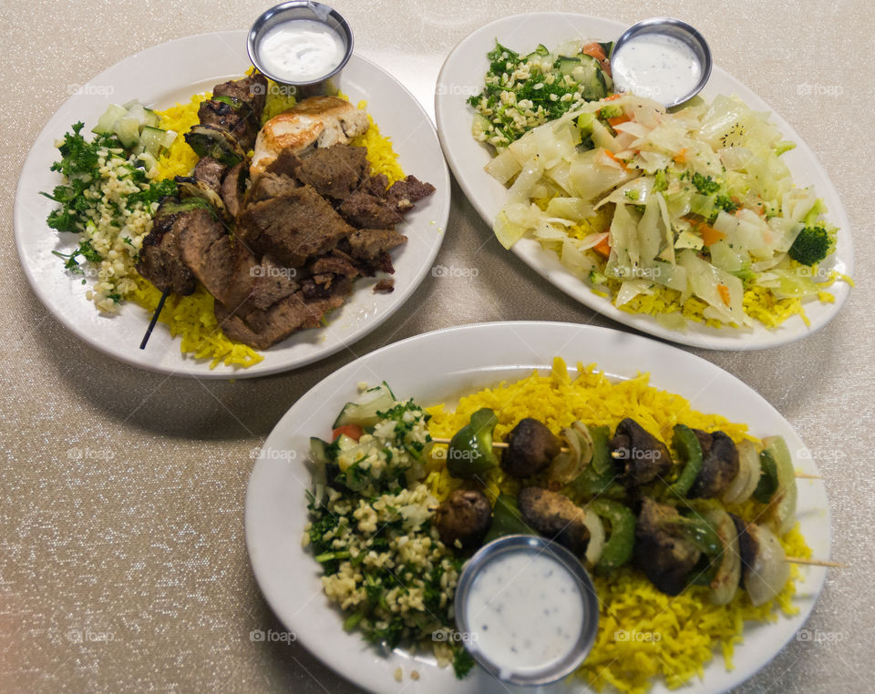 Turkish food at its finest: on the upper left is a gyro plate, upper right is a vegetable plate and the middle bottom is a veggie kebab plate. The gyro plate is the best among the 3.