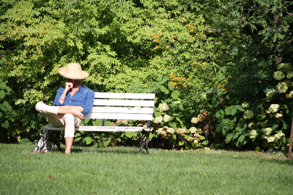 Man is sitting on a bench in the park