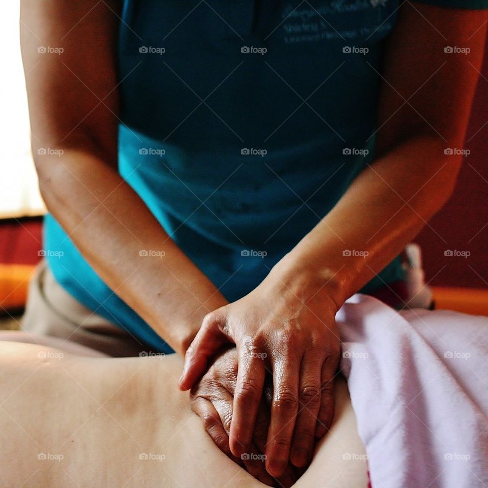 Person giving massage therapy