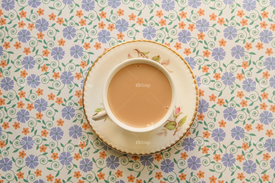 Milky tea on a floral background 