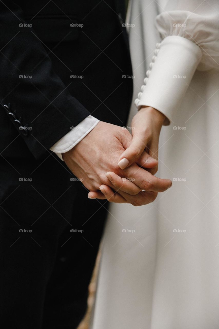 Holding hands of bride and groom. Wedding manicure