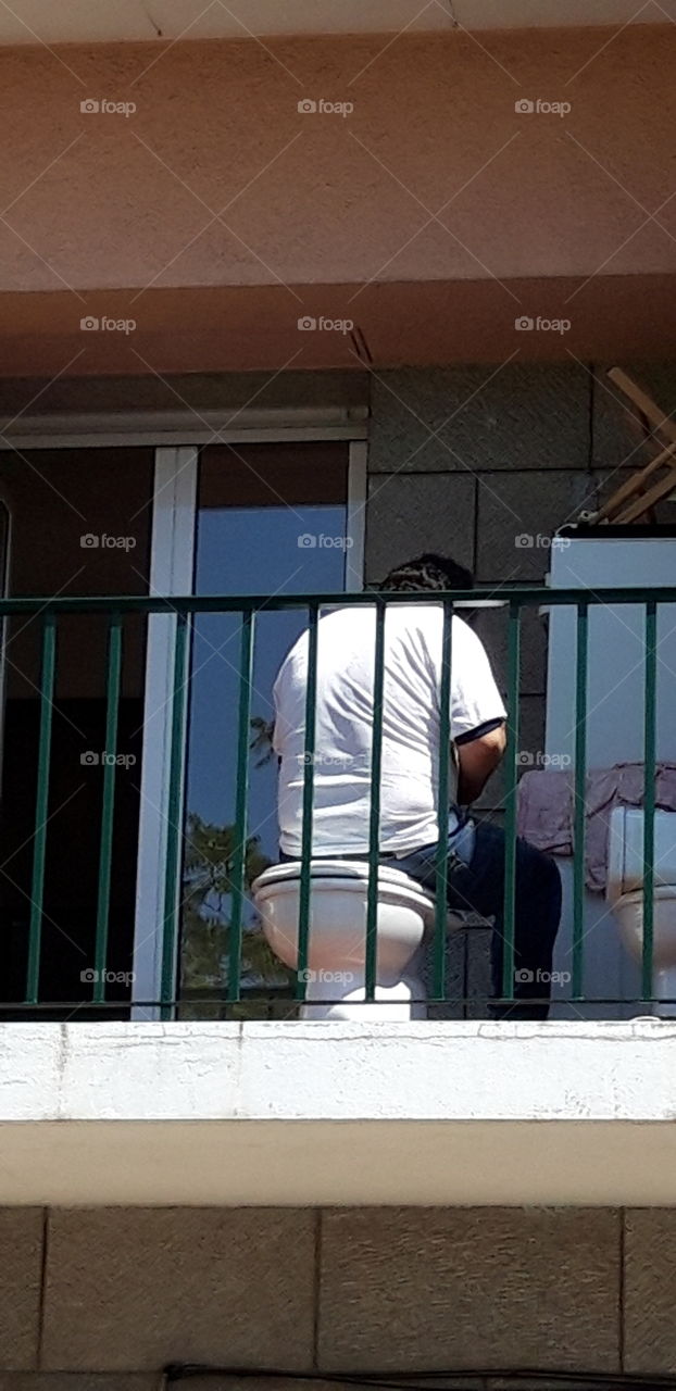 man on balcony in Lisbon