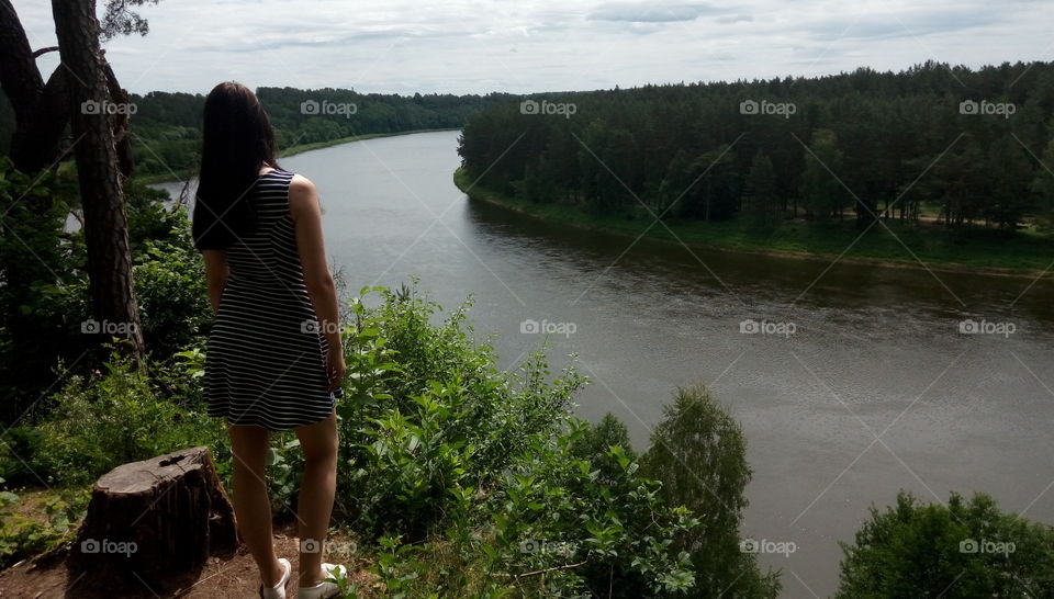women standing on a cliff