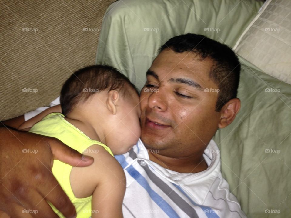 Close-up of a daughter resting with her father