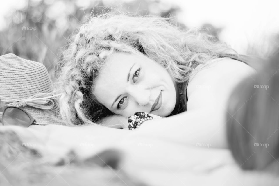 portrait of a curly girl. monochrome portrait of a curly blond girl