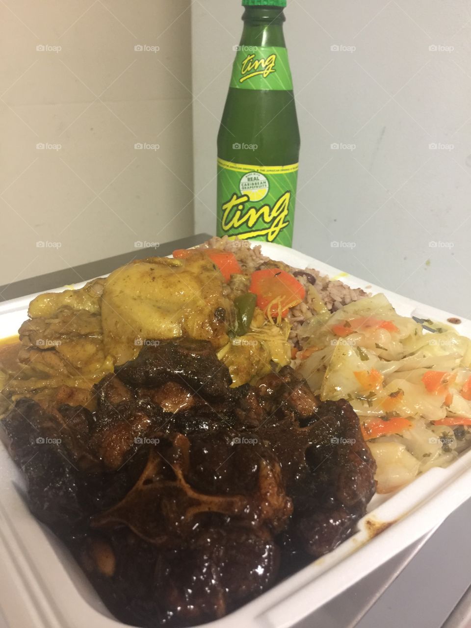 Curried Chicken/oxtails combination red beans and rice and cabbage