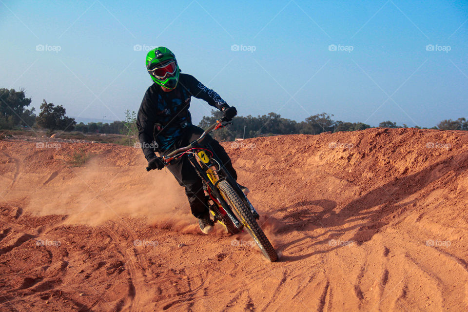 Biker drifting on dust
