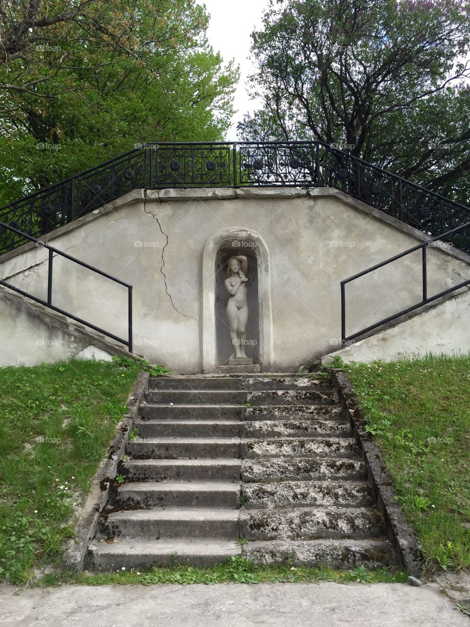 Half destroyed staircase  to a statue of a young woman in Olesko Castle, Ukraine