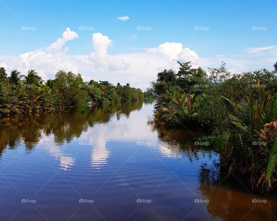 Scenic view of river against blue sky