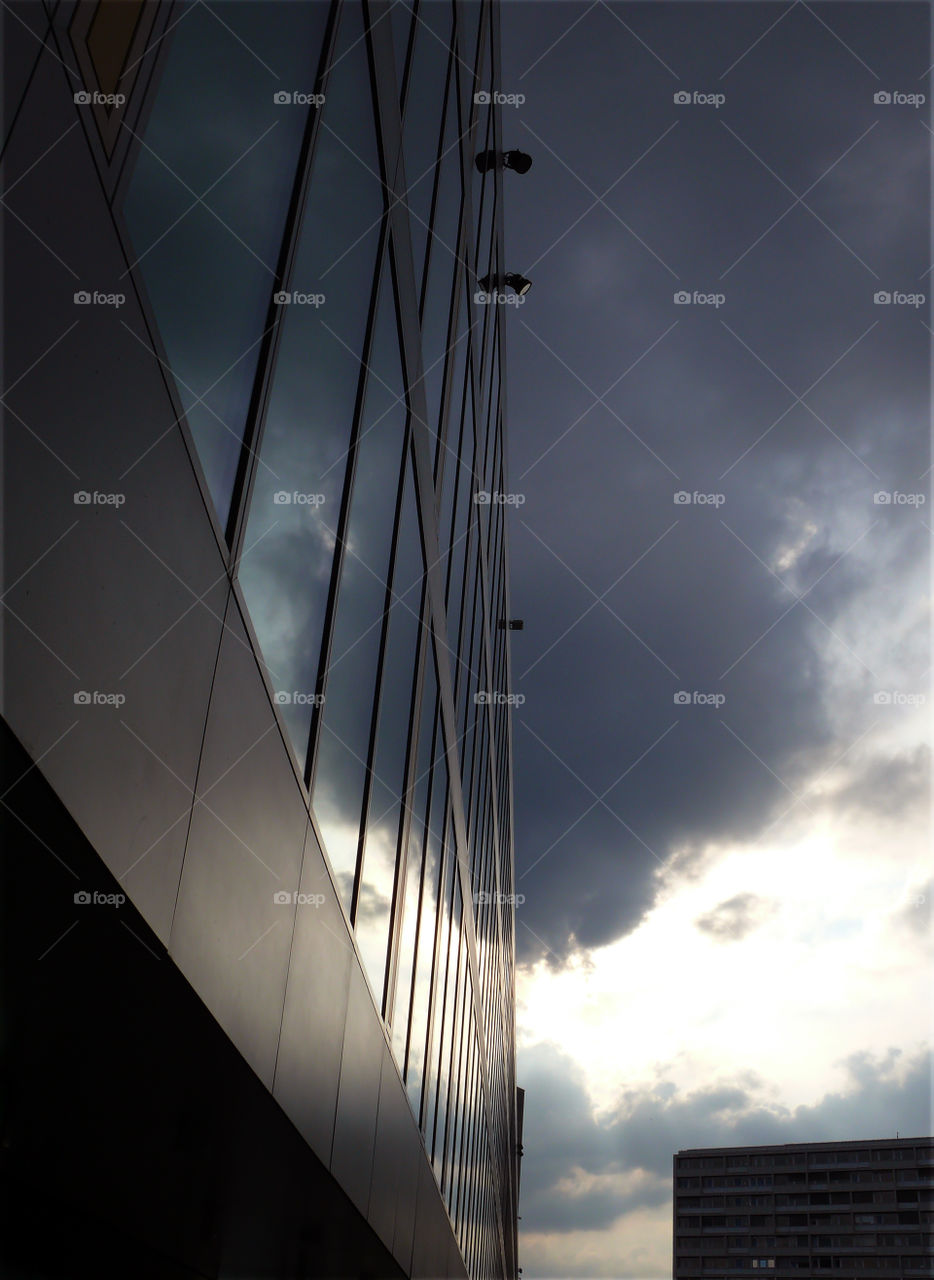 Low angle view of building exterior against cloudy sky in Berlin, Germany.