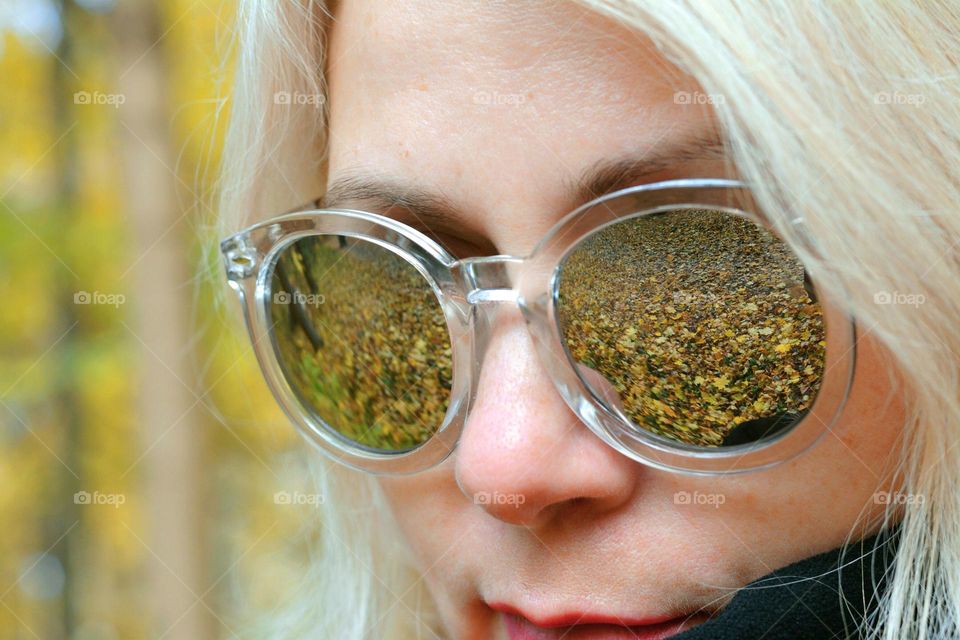 woman and autumn leaves reflection in mirror